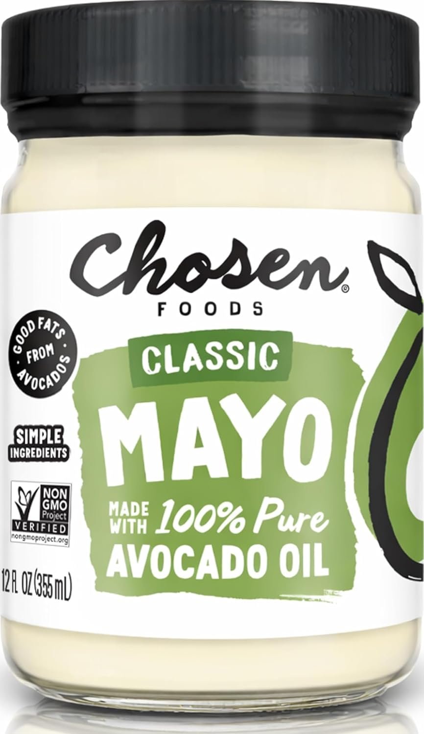 Chosen Foods avocado oil mayo jar on kitchen counter surrounded by fresh avocados and kitchen items in natural morning light