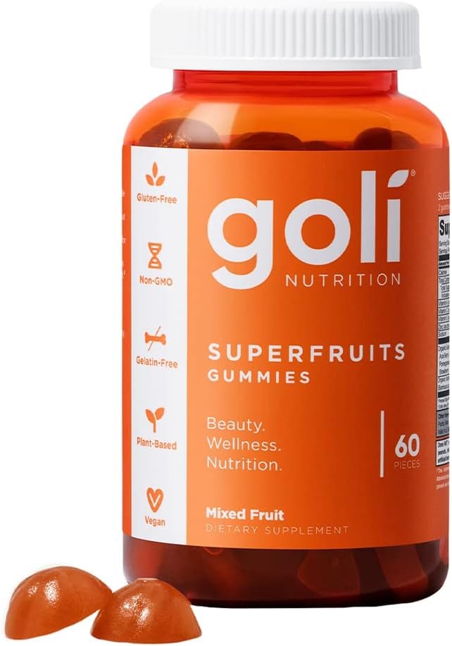 Goli Superfruits gummies bottle on a bright bathroom vanity shelf with skincare items and plant, daytime window light