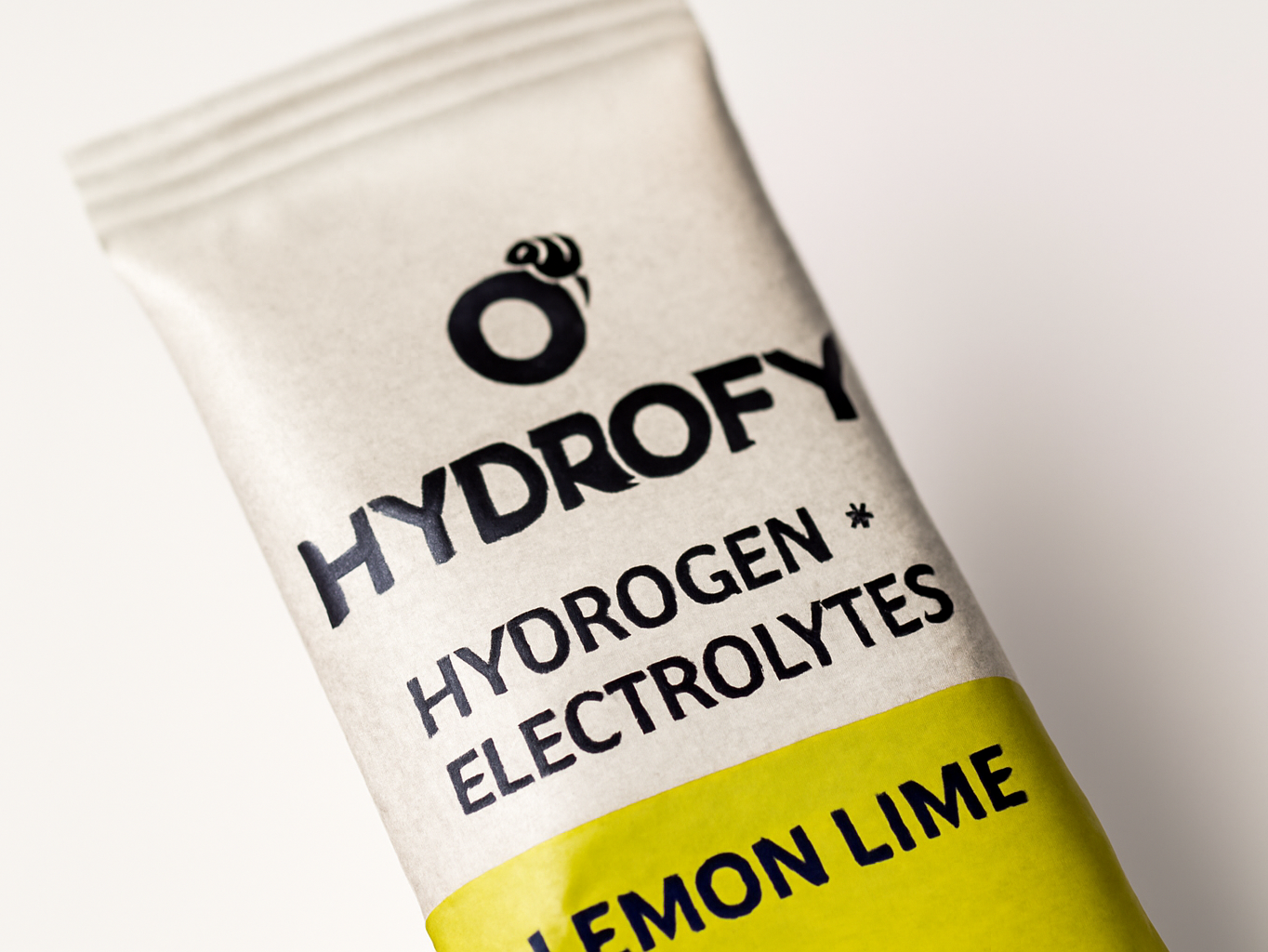 Hydrofy hydrogen water packet in extreme close-up showing powder granules and packet detail