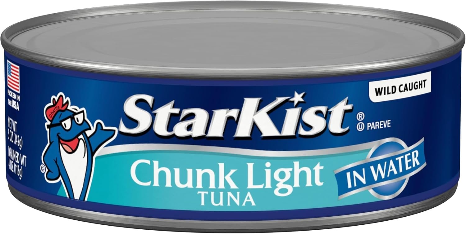 StarKist tuna can on kitchen counter next to fresh salad vegetables in home kitchen setting