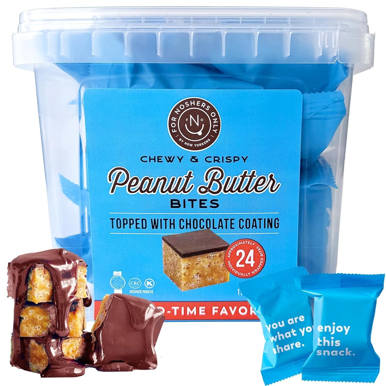 Box of peanut butter bites open on an office desk surrounded by work items and supplies