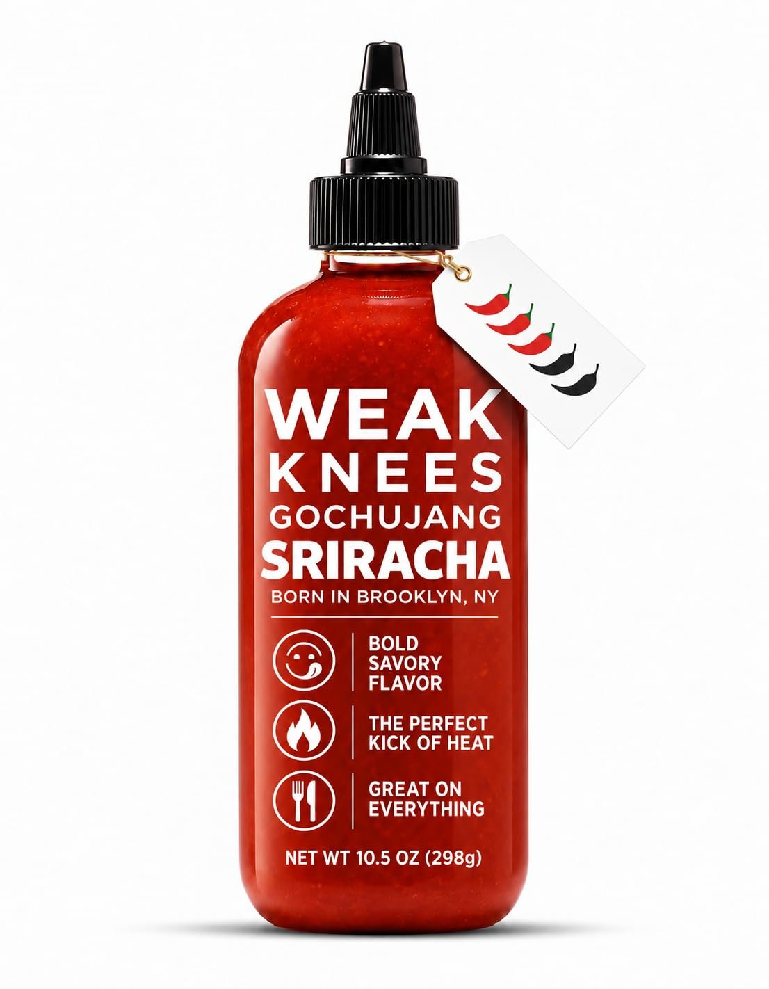 Gochujang Sriracha bottle on a kitchen counter surrounded by fresh peppers and Asian ingredients in daylight